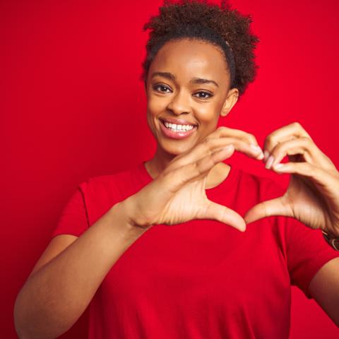 woman making a heart shape with her hands