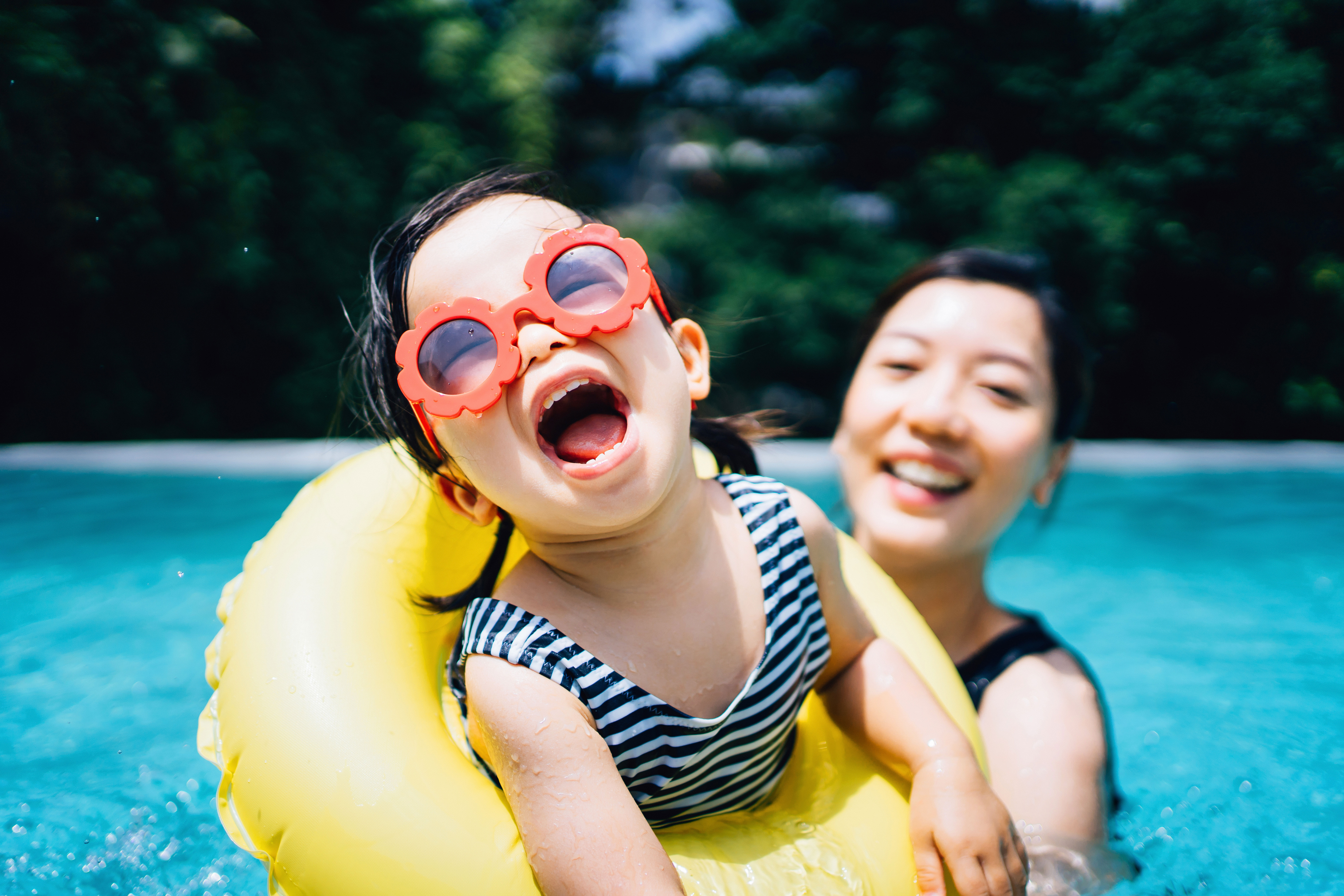 Mother and daughter laughing in the pool